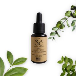 Facial serum bottle with green leaves.