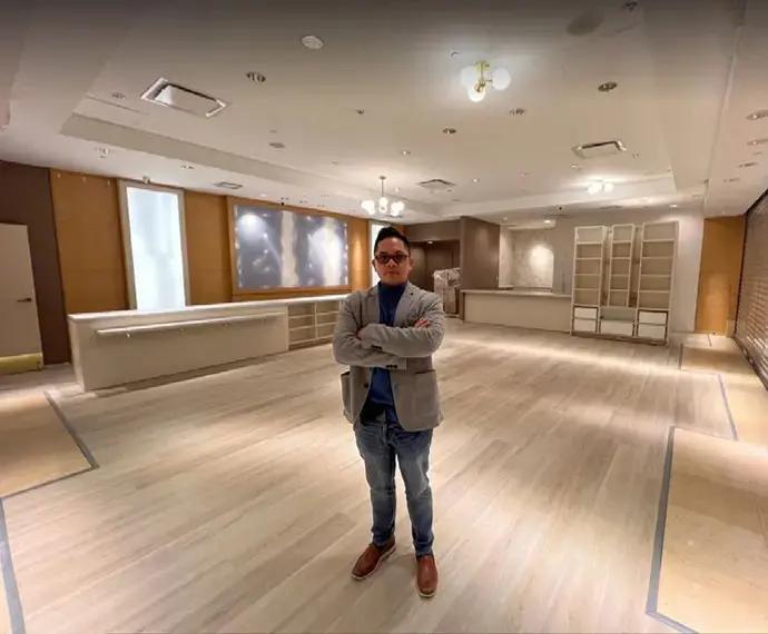 Man standing in an empty store.